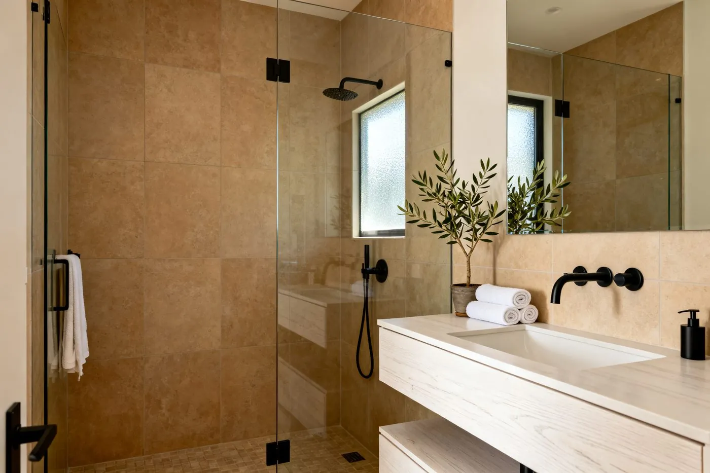 Renovated bathroom with walk-in shower and warm tile finishes
