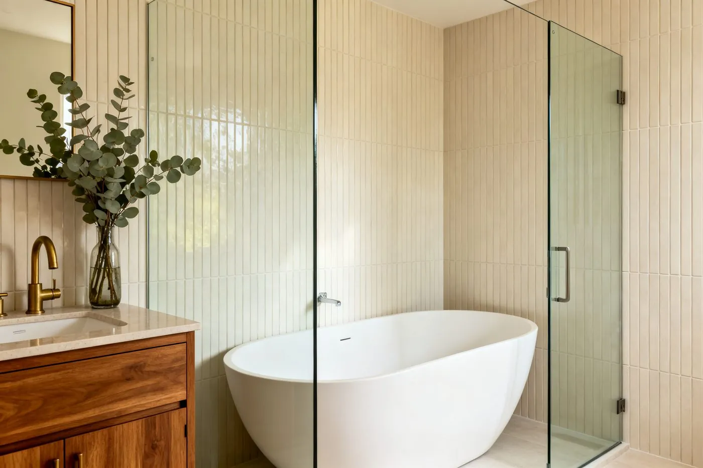Spa-inspired bathroom renovation with freestanding tub and glass shower enclosure