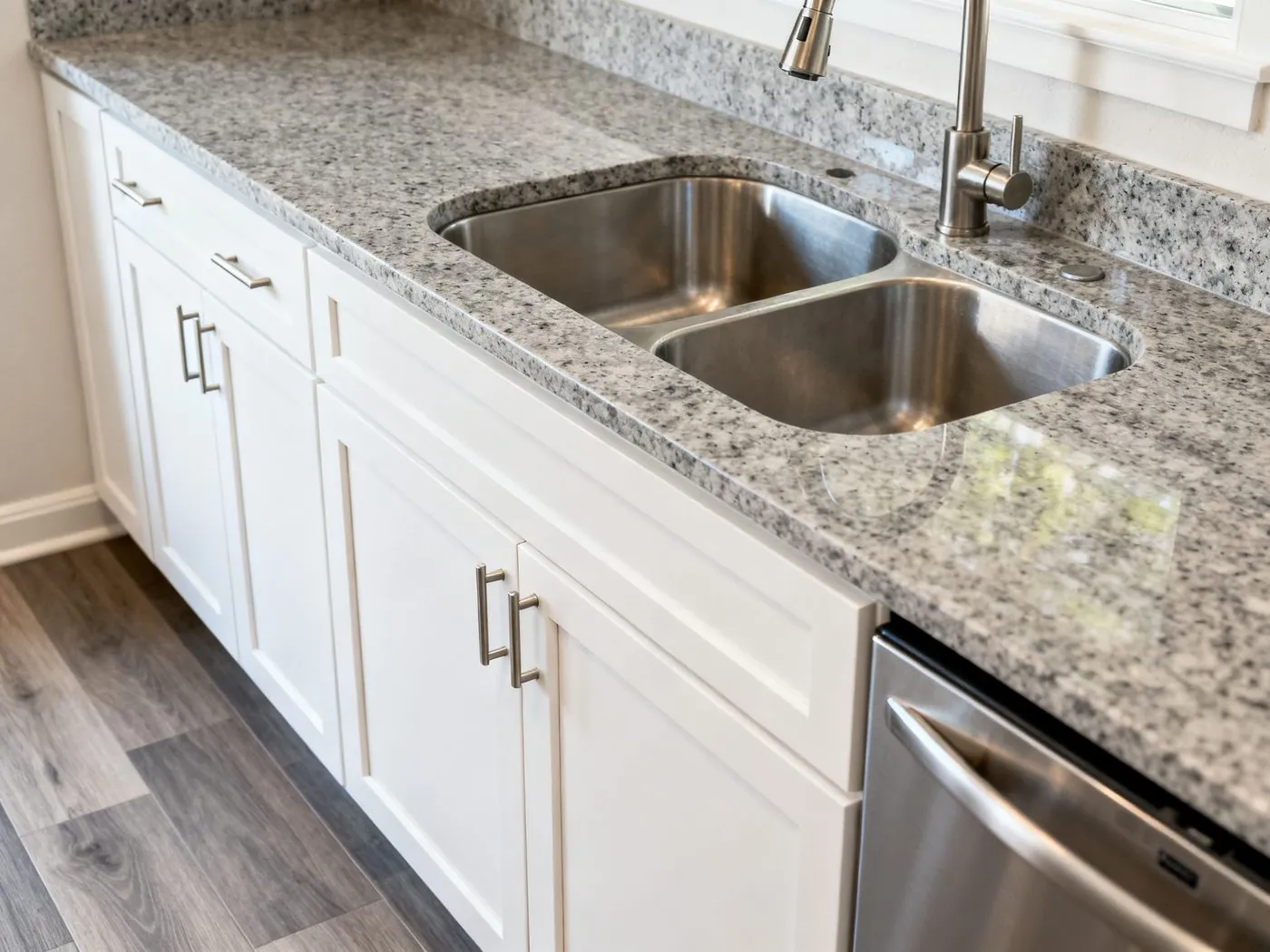 Durable rental kitchen finishes — white shaker cabinets, quartz countertop and vinyl plank flooring